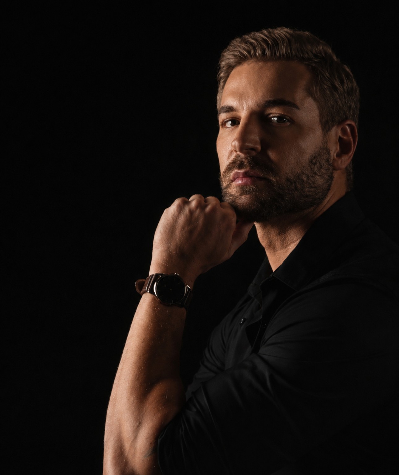 Justin Duwe, creator of Chemsex Freedom, sitting in low warm light against a black background